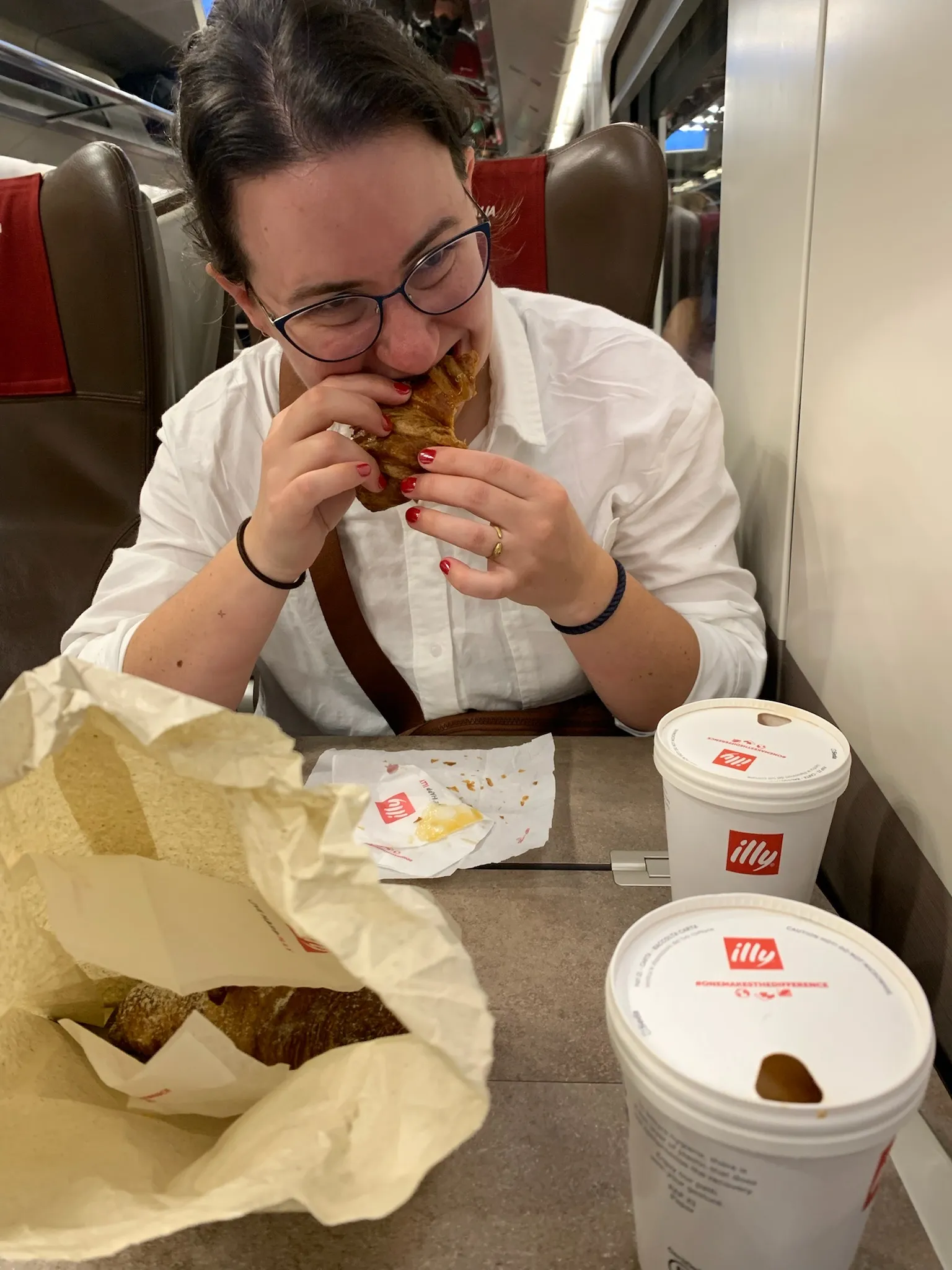 Ariel, cronching a croissant on the train to Venice